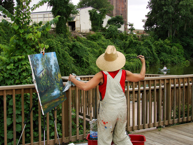 Artist Lisabelle painting Plein-Air at the beautiful "Swan Creek Riverwalk" August 2009, near the Erie Street Farmer's Market and Libby Glass Outlet.